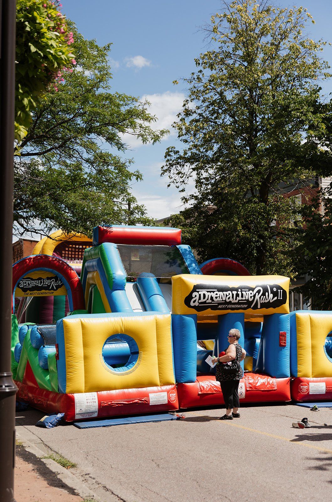 Children playing on a large inflatable slide at the kids' area.